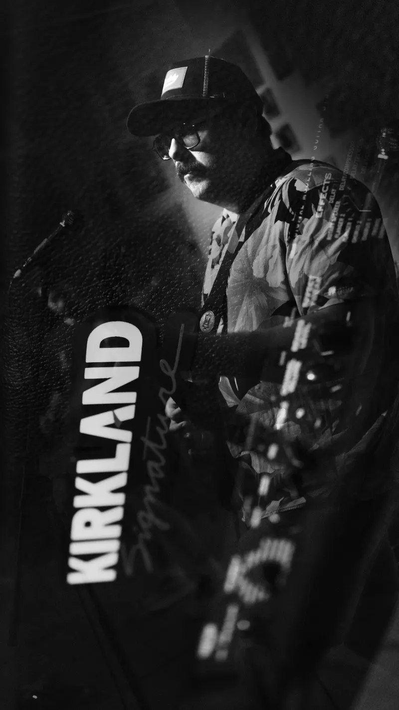 Sod The Earth guitarist in a Kirkland Signature shirt, black and white